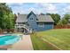 Spacious backyard with a pristine pool, lush lawn, and a two-story home, perfect for outdoor relaxation at 150 Surrey Chase Dr, Social Circle, GA 30025