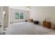 Spacious bedroom with a large window, neutral walls, carpet flooring, and simple furnishings creating a versatile space at 150 Surrey Chase Dr, Social Circle, GA 30025