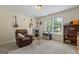 Cozy bedroom featuring a recliner, guitars, window, and carpet floors offering comfort and style at 150 Surrey Chase Dr, Social Circle, GA 30025