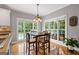 Cozy breakfast nook with abundant natural light, wooden table with chairs, and an adjacent view of the community pool at 150 Surrey Chase Dr, Social Circle, GA 30025