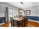Elegant dining room with wainscoting, hardwood floors, and a large table perfect for hosting dinner parties at 150 Surrey Chase Dr, Social Circle, GA 30025