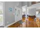 Inviting entryway with hardwood floors, columns, and an ornate glass insert front door that allows natural light to fill the space at 150 Surrey Chase Dr, Social Circle, GA 30025
