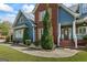 Charming two-story home featuring a brick accent wall, manicured landscaping, and a welcoming front porch at 150 Surrey Chase Dr, Social Circle, GA 30025