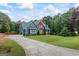 Two-story home featuring blue siding, a long driveway, well-manicured lawn and a detached garage at 150 Surrey Chase Dr, Social Circle, GA 30025