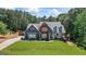 Inviting two-story home boasts a well-kept lawn, brick and blue siding, and charming curb appeal at 150 Surrey Chase Dr, Social Circle, GA 30025