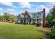 Beautiful two-story home showcasing a large lawn, brick and blue siding, and inviting curb appeal at 150 Surrey Chase Dr, Social Circle, GA 30025