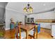 Well-lit kitchen with stainless steel appliances, a contrasting island, white cabinets, and hardwood flooring at 150 Surrey Chase Dr, Social Circle, GA 30025