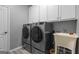 Functional laundry room equipped with modern washer, dryer, utility sink, and storage cabinets at 150 Surrey Chase Dr, Social Circle, GA 30025