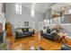 This bright living room features tall ceilings, fireplace, hardwood floors, and large windows providing bright, natural light at 150 Surrey Chase Dr, Social Circle, GA 30025