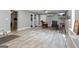 Spacious living room with wood-look floors, TV, mini-split AC, and neutral paint at 150 Surrey Chase Dr, Social Circle, GA 30025