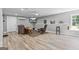 Cozy basement space featuring wood-look floors, TV area, comfortable seating, and a bright window for natural light at 150 Surrey Chase Dr, Social Circle, GA 30025