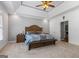 Spacious main bedroom with tray ceiling, large bed, and ample natural light at 150 Surrey Chase Dr, Social Circle, GA 30025
