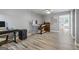 Office space showcasing wood-look floors, desk area, a computer, and a glimpse into an adjoining room at 150 Surrey Chase Dr, Social Circle, GA 30025