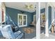Covered outdoor porch with wood ceiling, ceiling fan, seating and access to the backyard at 150 Surrey Chase Dr, Social Circle, GA 30025