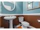 Charming powder room featuring a pedestal sink, elegant fixtures, and stylish wall finishes at 150 Surrey Chase Dr, Social Circle, GA 30025