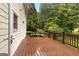 Outdoor back deck with stained wood and railing overlooking a lush backyard with mature trees and landscaping at 1014 Overlook Dr, Villa Rica, GA 30180
