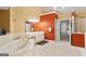 Bathroom featuring a spa bathtub with neutral tile flooring, contrasting the orange accent wall at 1014 Overlook Dr, Villa Rica, GA 30180