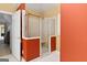 Bathroom with a glass-enclosed shower and orange accent wall, adjacent to a closet and neutral-colored walls at 1014 Overlook Dr, Villa Rica, GA 30180