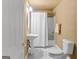 Bathroom with a pedestal sink, standard toilet, and shower/tub combo with white tile surround and shower curtain at 1014 Overlook Dr, Villa Rica, GA 30180