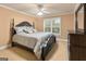Comfortable bedroom featuring a ceiling fan, neutral-colored walls, and a window with stylish shutters at 1014 Overlook Dr, Villa Rica, GA 30180