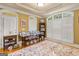 Bright bedroom featuring shuttered windows, tray ceiling, and a table showcasing decor and picture frames at 1014 Overlook Dr, Villa Rica, GA 30180