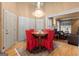 Elegant dining room featuring a chandelier, round table with red chairs, and a clear view to the living area at 1014 Overlook Dr, Villa Rica, GA 30180
