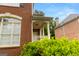 A brick home with a covered front porch and large window, showcasing classic architectural details and curb appeal at 1014 Overlook Dr, Villa Rica, GA 30180