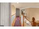 Upstairs hallway featuring hardwood floors, white trim, and a decorative rug leading to various rooms at 1014 Overlook Dr, Villa Rica, GA 30180