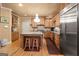 Bright kitchen boasts stainless steel appliances, granite countertops, a central island, and wood floors at 1014 Overlook Dr, Villa Rica, GA 30180