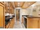 A kitchenette with wood cabinets, dark countertops, and stainless steel appliances, perfect for convenience at 1014 Overlook Dr, Villa Rica, GA 30180