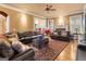 Spacious living room with a leather sofa, brick fireplace, and an open view into the adjacent dining area at 1014 Overlook Dr, Villa Rica, GA 30180