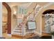 Elegant staircase featuring wood steps and white spindles, complemented by natural light and decorative artwork at 1014 Overlook Dr, Villa Rica, GA 30180