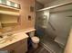 Full bathroom with a glass-enclosed shower, vanity, and commode at 3346 Northcrest Rd # A, Atlanta, GA 30340