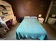 Comfortable bedroom featuring a blue comforter, dark-toned accent wall, and a desk for functionality at 3346 Northcrest Rd # A, Atlanta, GA 30340