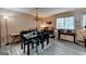 Inviting dining room with a large table, chandelier, and plenty of natural light from the large window at 3346 Northcrest Rd # A, Atlanta, GA 30340
