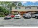 Exterior view of a multi-Gathering home with brick and siding, surrounded by trees and parked cars at 3346 Northcrest Rd # A, Atlanta, GA 30340