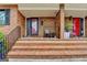 Charming brick front porch with steps, black railing, and classic mailbox, leading to a red front door at 3346 Northcrest Rd # A, Atlanta, GA 30340