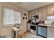 Bright kitchen featuring gray cabinets, stainless steel appliances, and a cozy breakfast nook with natural light at 3346 Northcrest Rd # A, Atlanta, GA 30340