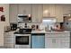 Stylish kitchen with gray cabinets, stainless steel appliances, white countertops, and a subway tile backsplash at 3346 Northcrest Rd # A, Atlanta, GA 30340