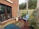 Enclosed patio area featuring a brick facade, wood fence, and comfortable outdoor seating at 3346 Northcrest Rd # A, Atlanta, GA 30340