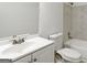 Bright bathroom featuring a white vanity, toilet, framed mirror and shower-tub combo with tiled walls at 4651 Garden Hills Dr, Stone Mountain, GA 30083