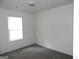 A neutral-toned bedroom with a window providing natural light and simple, clean design at 4651 Garden Hills Dr, Stone Mountain, GA 30083
