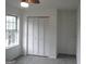 A simply-designed bedroom features a large closet and a window providing natural light at 4651 Garden Hills Dr, Stone Mountain, GA 30083