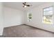 Spacious, bright bedroom featuring neutral colored walls and carpet and a ceiling fan at 4651 Garden Hills Dr, Stone Mountain, GA 30083