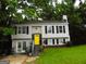 Charming home with a bright yellow front door, black shutters, and a well-maintained lawn at 4651 Garden Hills Dr, Stone Mountain, GA 30083