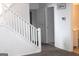 Well-lit hallway featuring a staircase, white trim, and modern wall-mounted security system at 4651 Garden Hills Dr, Stone Mountain, GA 30083
