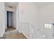 Upstairs hallway leading to bedrooms featuring white railing and neutral colored walls at 4651 Garden Hills Dr, Stone Mountain, GA 30083