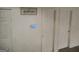 Hallway with doors, featuring a wall-mounted control panel and a welcoming sign at 4651 Garden Hills Dr, Stone Mountain, GA 30083