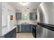 Modern kitchen with stainless steel appliances, gray cabinets, and subway tile backsplash at 4651 Garden Hills Dr, Stone Mountain, GA 30083