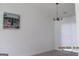 A well-lit living room with a modern chandelier and an eye-catching decorative wall painting at 4651 Garden Hills Dr, Stone Mountain, GA 30083